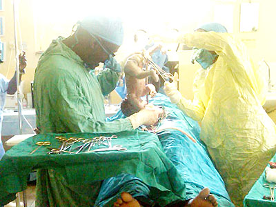 Doctors do finishing touches on a baby born by caesarean section. Many women today are avoiding the pangs of labour pains by going for the technological birth style.  Net photo.