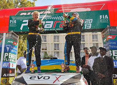 Giancarlo Davite [R] with his navigator Slyvia Vindevogel celebrating their second place finish in Zambia international rally this month. The New Times/Courtesy