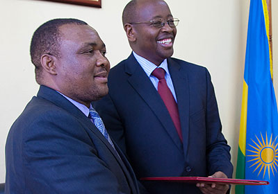 Lesothou2019s Methetjo Metsing (L) and Musoni exchange memorandum of understanding files after the two officials signed the bilateral treaty in Kigali yesterday. The New Times / Timothy Kisambira