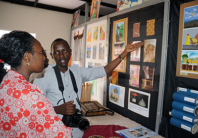 A student displays creative artworks at the exhibition on Tuesday. The New Times/ John Mbanda.