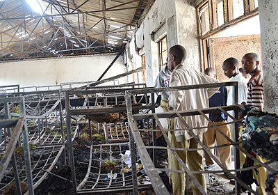 Students look at the remains of burnt property after fire gutted a dorm last month. The New Times/ File.