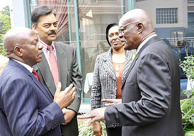 Sendawula (R) and Dr Bukuku (L) chat as Vimal Shah looks on after the meeting in Arusha at the weekend. The New Times/Stephen Rwembeho.