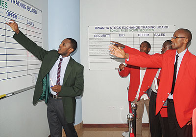 Bourse traders during a session. The CMA seeks to expand the stock market. The New Times / File