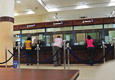 Customers carrying out transactions at a city bank. Most banksu2019 first quarter performance results are encouraging. The New Times / File photo