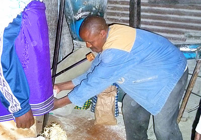 Munyamfura attends to his grain mill last week. The New Times/ Seraphine Habimana.