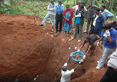 Volunteers remove the newly-found remains. The New Times/ S. Rwembeho.