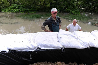 Hungarians, including soldiers and volunteers, reinforce dykes along the Danube River. Net photo.