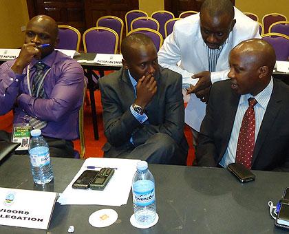 The M23 Head of Communications, M Bertrand Bisiimwa (right) during discussions with some of the members of his delegation during the ongoing Kampala talks. Sunday Times/Net photo.