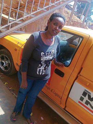 Rurangwa poses for a photo next to one of the company cars. The New Times / Peterson Tumwebaze