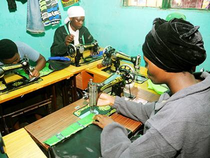 Women engaged in tailoring, one of the small scale enterprises that helps uplift their economic status. The New Times/ John Mbanda.