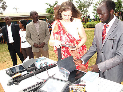 Jenny Oakley hands over the iPads to school head teachers. The New Times / Stephen Rwembeho.