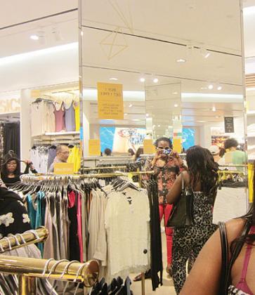 The writer (holding camera) inside Kuala Lumpuru2019s H&M store.