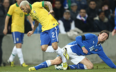 Italy's Montolivo battles with Brazil defender Dani Alves during a recent international friendly. Net photo