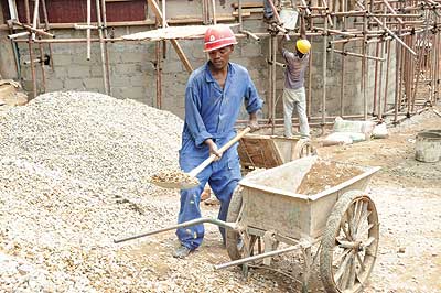 Workers at a construction site. The 25% imposed on building materials in the 2013/14 budget will make it hard for people to acquire homes or rent decent houses, according sector experts. The New Times / Timothy Kisambira 