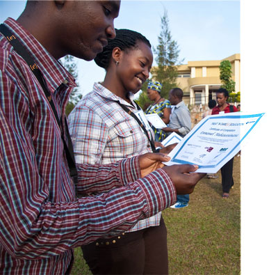 Emmanuel Muhawenimana (L) and Marie Colombe admire their  certificates after the award ceremonies in Kigali yesterday. The New Times/ Timothy Kisambira. 