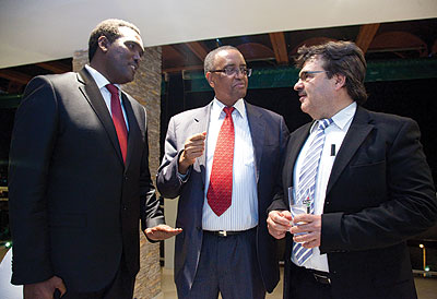 Lwakabamba (middle) talks with other guests at the launch of XXL. The New Times/ Timothy Kisambira