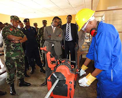 A plumbing students demonstrate what he has learnt as ministers Biruta and Kabarebe look on. Saturday Times/ Jean Pierre Bucyensenge