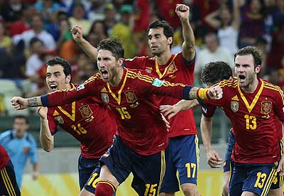 Spanish players run on the field to celebrate after beating Italy on penalties and book a place in the final against hosts Brazil. 