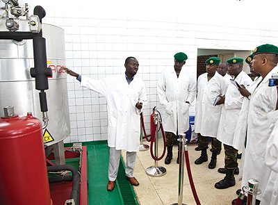 Niyibizi Ananie, a senior research technician at the IRST Kigali research station, explains to Rwanda Defence Forces personnel how bio-disiel is produced. The New Times / File photo