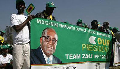 ZANU PF party supporters hold a banner of their presidential candidate during the rally to launch his re-election campaign on July 5 2013 at the Zimbabwe Grounds in Harare. President Robert Mugabe has launched his re-election campaign. Net photo.