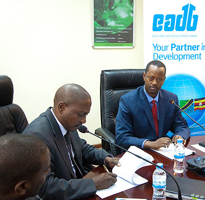 Duncan Mwesigye (left), the EADB Uganda country manager and former BRD boss Jack Kayonga sign the Rwf6.5b loan deal last week. The New Times / File