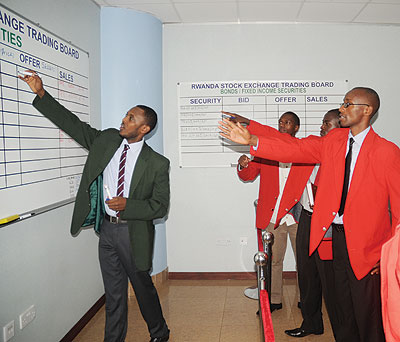 Dealers during a market session earlier this year. The bourse is set to get a boost when Uchumi finally cross-lists on the local stock exchange.  The New Times / File