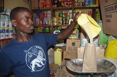 A trader measures sugar. The price of sugar is unchanged at Rwf800 a kilogramme in most markets across the city. The New Times / File photo