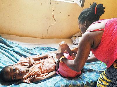 Jeanine Kankera attends to Esperance at their home in Kinyinya. Sunday Times/John Mbanda