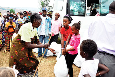 Pupils of HKA handing over foodstuffs to Genocide survivors. The New Times/Courtesy photo