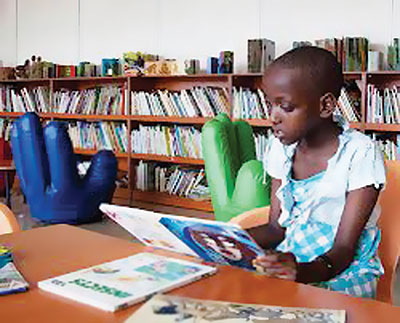 A school girl reads a book. The local publishing and printing sectors is facing hard times.  The New Times / File photo