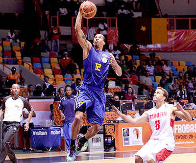 Rwanda's Kenneth Gasana scores against Tunisia. He is the top-scorer in the 2013 Afrobasket championship in Abidjan. The New Times / Courtesy.