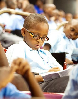 A pupil takes notes during a seminar. Private tutoring remains a subject of debate. Courtesy.