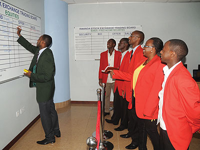 Dealers during a trading session on the main stock market. The bourse will soon list SMEs on the alternative market segment. The New Times/File