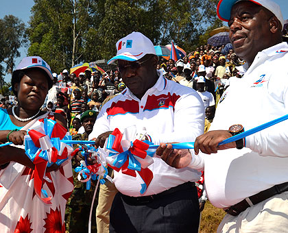 RPF Commissioner Habumuremyi (C), Northern Province RPF chief Aimu00e9 Bosenibamwe, (R) and Winifride Mpembyemungu, the RPF chairperson in Musanze District cut tape to signify the opening of the RPF campaign in Musanze. The New Times/Jean du2019Amour Mbonyinshuti