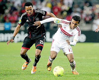 Tlou Segolela of Orlando Pirates battles with Mohamed Abdel Shafi Sayed Abouezeid of Zamalek during the CAF Champions League first leg match. Net photo.