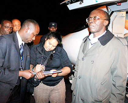 Officials clear the formalities for the extradition of Mugesera at Kigali International Airport. The New Times/ File.