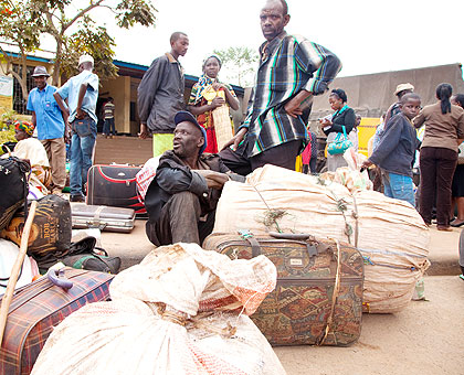 Some of the evictees from Tanzania await for assistance on arrival in the country recently. The New Times/ File.