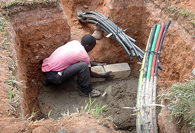 A man lays a fibre optic cable. Rwanda is among a few countries in Africa set to roll-out a high-speed 4G broadband network that delivers download speed of up to 100 Megabytes per ....