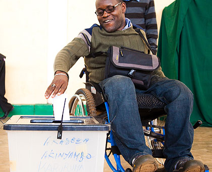 A disabled person casting his ballot yesterday. The New Times/Timothy Kisambira