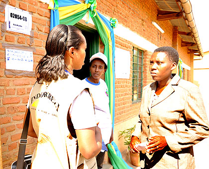 An observer talks to polling officials on Wednesday. The New Times/ John Mbanda.