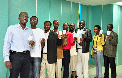 Rwandans in New Delhi, India,   proudly show off their voteru2019s cards before voting on Monday.    The New Times/Courtsey. 