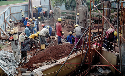 Workers at a building site. The Government is to issue construction policy to streamline the sector. The New Times /File Photo