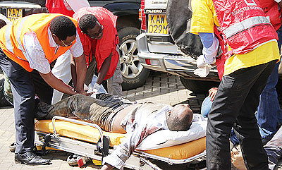 Medics attend to a wounded man outside the Westgate shopping mall in Nairobi, Kenya, Sept. 21, 2013. Net photo.