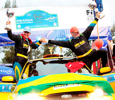 Winners-Giancarlo Davite and navigator Sylvia Vindevogel celebrate their 2013 Rwanda Mountain Gorilla titles yesterday at PSF Gikondo grounds.  The New Times / Plaisir Muzogeye.