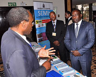 Prime Minister Pierre Damien Habumuremyi (R) listens to a participant from Nairobi University. The New Times, John Mbanda