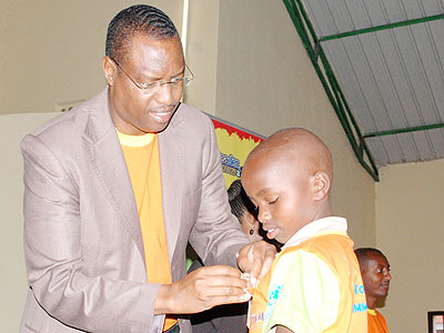 Mitali decorates a pupil after the competition. The New Times/JP Bucyensenge