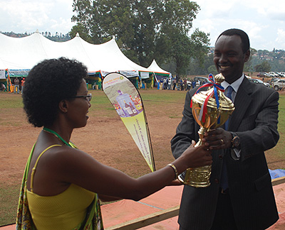 Minicom PS Hategeka (R) awards a trophy to an exhibitor from Ubuzima Animals processing which emerged the best in the Industry category.  The New Times/Jean Pierre Bucyensenge