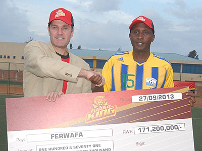 Bralirwau2019s Marketing Director Jan Van Velzen and FA boss Celestin Ntagungira displaying the Turbo King dummy cheque on Friday. Times Sport/Courtesy