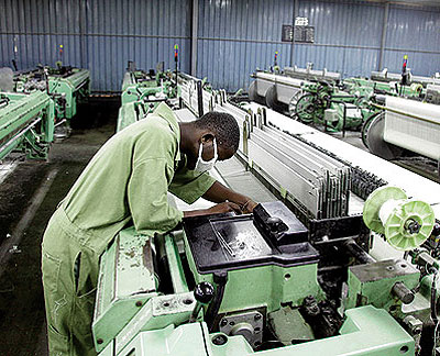 A textile worker checks equipment. EAC is seeking to have a harmonised industrial policy. File photo