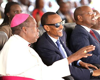 President Kagame listening to  Monsignor Smaragde Mbonyintege during the celebrations yesterday. Right is Local Government Minister James Musoni. The New TImes/Village Urugwiro